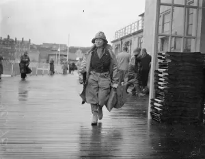 Women angler defies the gales at Hastings. With a stiff gale whipping up the sea Women angler defies the gales at Hastings. With a stiff gale whipping up the sea