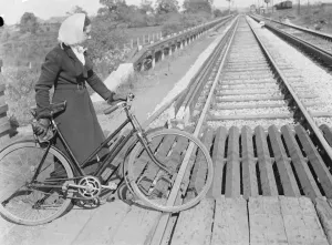 A women pushing her bicycle over the Shorne level crossing in Knet. 1939 A women pushing her bicycle over the Shorne level crossing in Knet. 1939