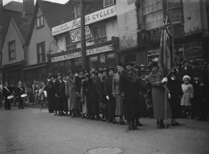The women of the Royal British Legion wait with their flag for the procession to The women of the Royal British Legion wait with their flag for the procession to