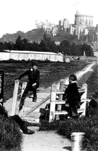 Four young boys playing games by the kissing gate with Windsor Castle in the background Four young boys playing games by the kissing gate with Windsor Castle in the background
