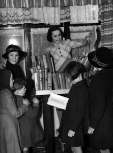 Young girl running a lending library for other schoolchildren. 1940's Young girl running a lending library for other schoolchildren. 1940's