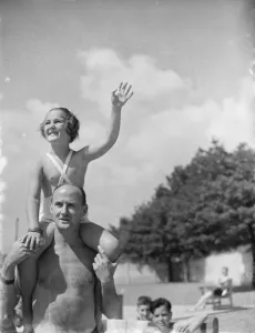 A young girl on the shoulders of her father at a swimming pool in Gravesend, Kent A young girl on the shoulders of her father at a swimming pool in Gravesend, Kent