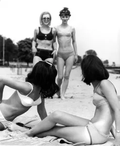 Four young women meet up at the beach for a relaxing time during their summer break Four young women meet up at the beach for a relaxing time during their summer break