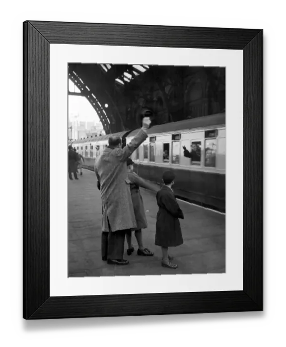 Framed Print : Train leaving St Pancras Station 1940 s. Father and sons waving goodbye from the platform Framed Print : Train leaving St Pancras Station 1940 s. Father and sons waving goodbye from the platform