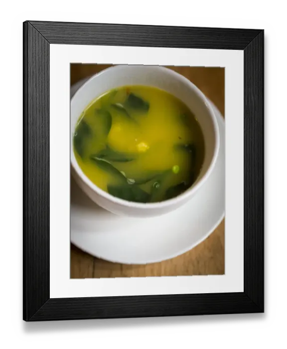 Framed Print : Light fresh soup made of lobster stock with saffron, prawns, peas and baby spinach