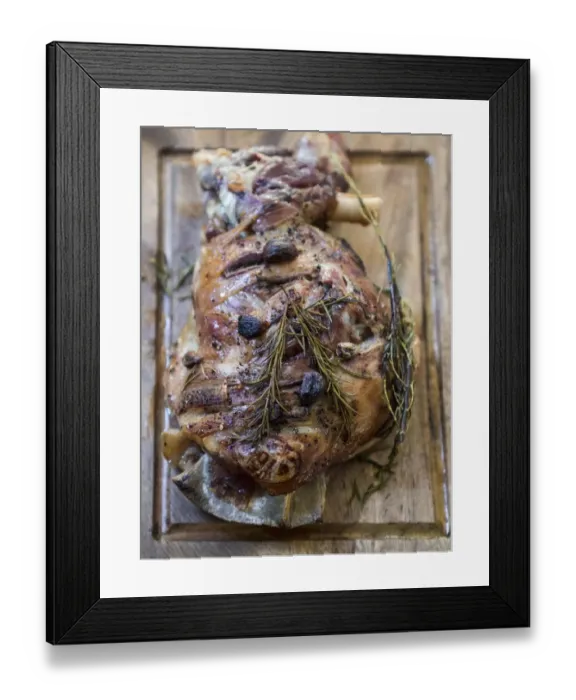 Framed Print : Slow roast shoulder of lamb with garlic and rosemary, on wooden carving board Framed Print : Slow roast shoulder of lamb with garlic and rosemary, on wooden carving board