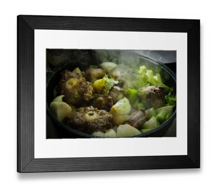 Framed Print : Oxtail casserole with onions and celery being started on top of stove before being Framed Print : Oxtail casserole with onions and celery being started on top of stove before being
