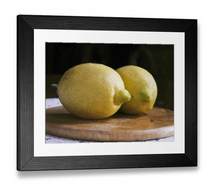 Framed Print : Two whole yellow lemons from Majorca on wooden board credit: Marie-Louise Avery