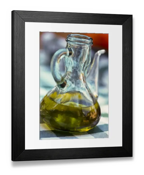 Framed Print : Bottle of olive oil on outdoor restaurant table in southern France, with reflection Framed Print : Bottle of olive oil on outdoor restaurant table in southern France, with reflection