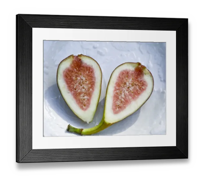 Framed Print : Halved ripe fig on white plate credit: Marie-Louise Avery  /  thePictureKitchen  /  TopFoto