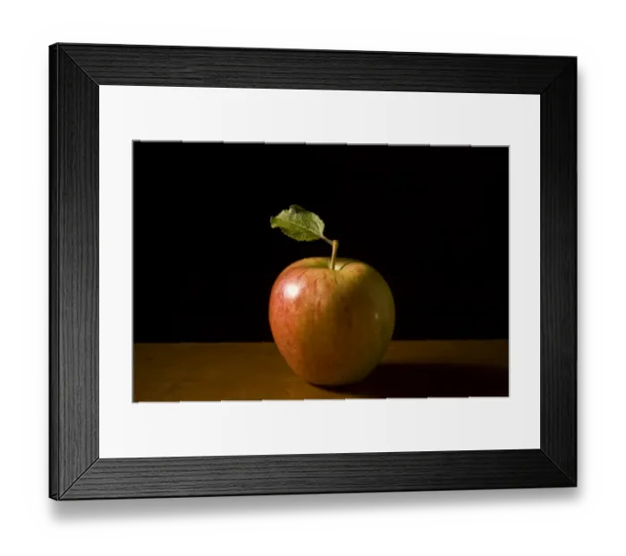 Framed Print : Apple with leaf on wooden surface against black background credit: Marie-Louise Framed Print : Apple with leaf on wooden surface against black background credit: Marie-Louise