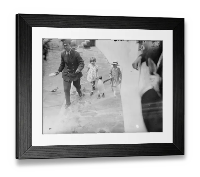 Framed Print : Taking the penguin to lunch. Two little visitors to the London Zoo taking a penguin