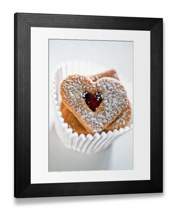 Framed Print : Pretty heart shaped biscuits in white paper muffin case9 credit: Marie-Louise Avery Framed Print : Pretty heart shaped biscuits in white paper muffin case9 credit: Marie-Louise Avery