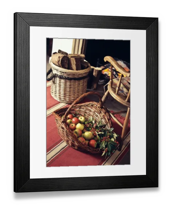 Framed Print : Big decorative basket of Coxs apples with sprays of ornamental berries by open fireplace Framed Print : Big decorative basket of Coxs apples with sprays of ornamental berries by open fireplace