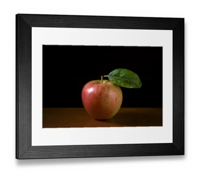 Framed Print : Apple with leaf on wooden surface against black background credit: Marie-Louise