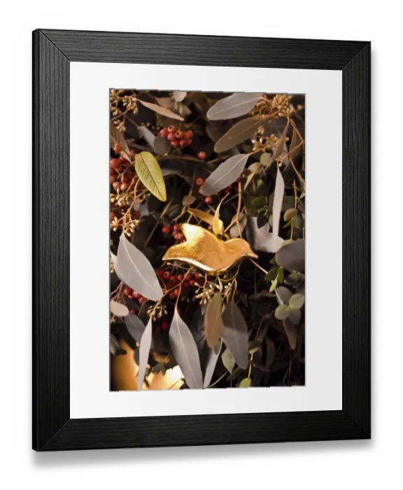 Framed Print : Detail of fireplace decorated for Christmas with massed mixed foliage and golden Framed Print : Detail of fireplace decorated for Christmas with massed mixed foliage and golden