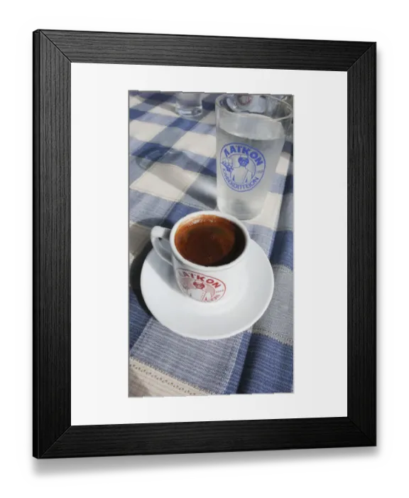 Framed Print : Little cup of strong Greek coffee, with glass of water on table of beach restaurant Framed Print : Little cup of strong Greek coffee, with glass of water on table of beach restaurant
