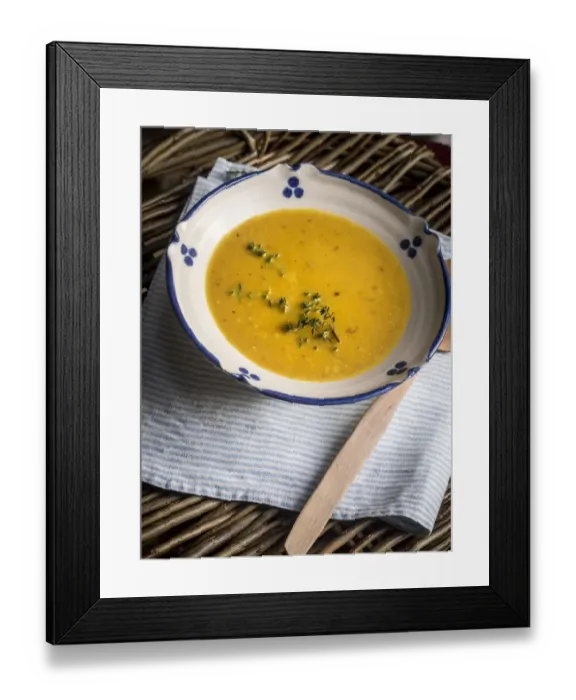 Framed Print : Soup of squash roasted with garlic and thyme, served in blue and white bowl with Framed Print : Soup of squash roasted with garlic and thyme, served in blue and white bowl with