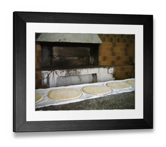 Framed Print : Large round flat loaves of bread rising on clean cloths on counter of quayside bakery