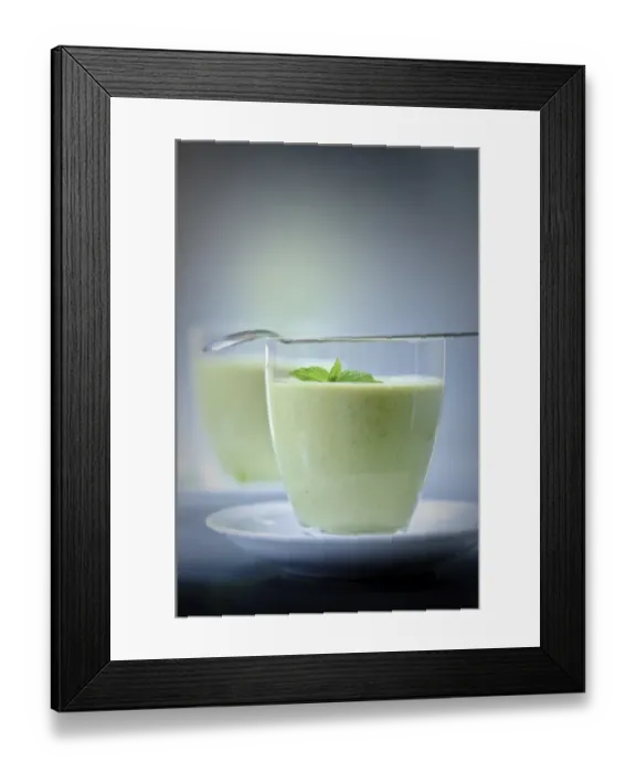 Framed Print : Chilled soup of fresh garden peas and courgettes in small glasses on white saucers Framed Print : Chilled soup of fresh garden peas and courgettes in small glasses on white saucers