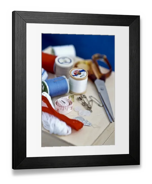 Framed Print : Various bits of sewing kit, including threads, needles and scissors on wooden box Framed Print : Various bits of sewing kit, including threads, needles and scissors on wooden box