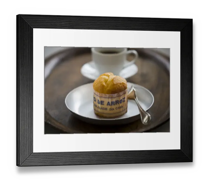 Framed Print : Classic Portuguese muffin type cake made with rice in paper wrapper on metal plate
