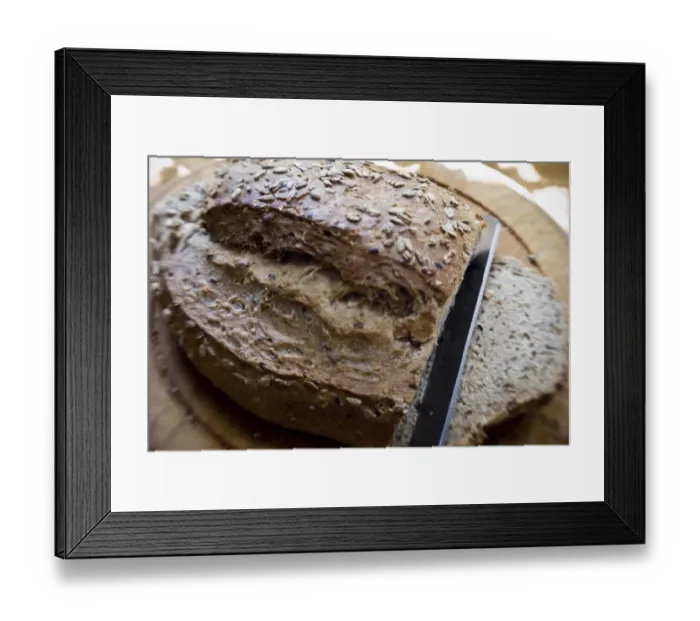 Framed Print : Slicing a wholegrain, rye and walnut loaf on old wooden board. credit: Marie-Louise Framed Print : Slicing a wholegrain, rye and walnut loaf on old wooden board. credit: Marie-Louise