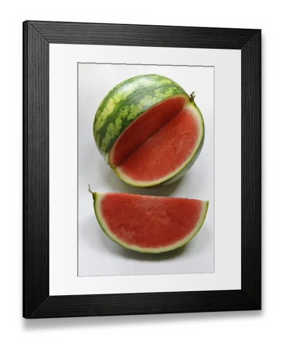 Framed Print : Small watermelon on white surface with quarter cut out showing red flesh credit Framed Print : Small watermelon on white surface with quarter cut out showing red flesh credit