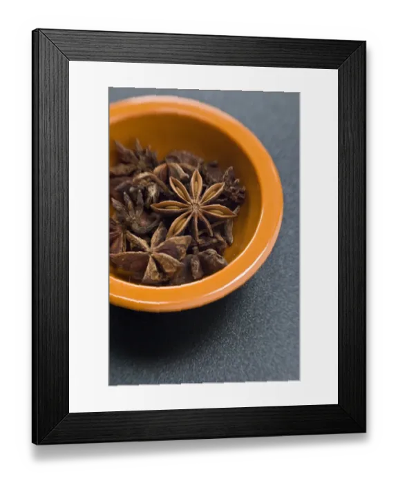 Framed Print : Dried Star anise fruits in small bowl. Also known as star aniseed, badiane or Chinese Framed Print : Dried Star anise fruits in small bowl. Also known as star aniseed, badiane or Chinese