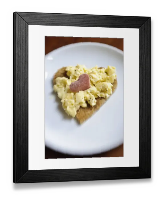 Framed Print : Valentines day breakfast of scrambled eggs on heart shaped toast with slice of salami Framed Print : Valentines day breakfast of scrambled eggs on heart shaped toast with slice of salami