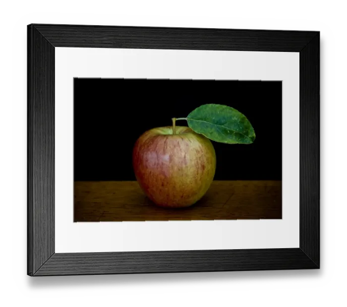 Framed Print : Apple with leaf on wooden surface against black background credit: Marie-Louise Framed Print : Apple with leaf on wooden surface against black background credit: Marie-Louise