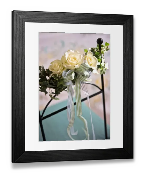Framed Print : Three white rooses with stripey ribbons and ivy leaves as decorations tied to chair