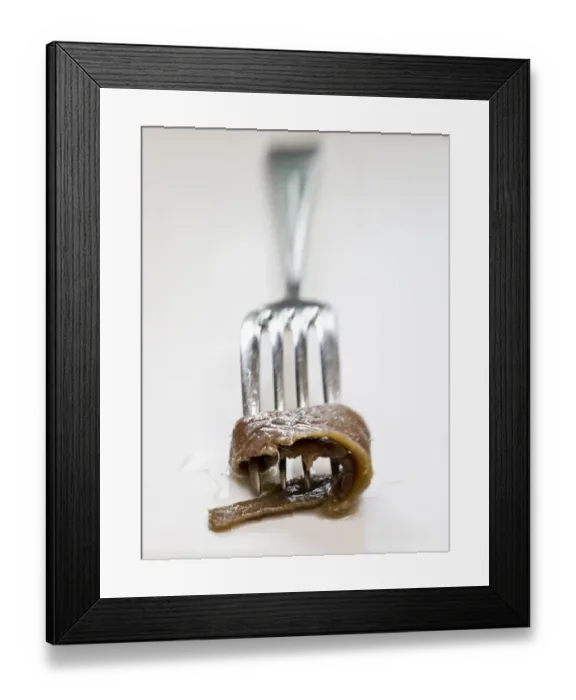Framed Print : Fillets of anchovies in oil in preserving jar, with single fillet on a fork credit