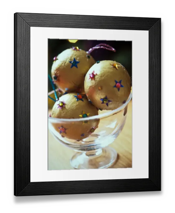 Framed Print : Gold christmas baubles with sequin stars in glass bowl as table centrepiece credit Framed Print : Gold christmas baubles with sequin stars in glass bowl as table centrepiece credit