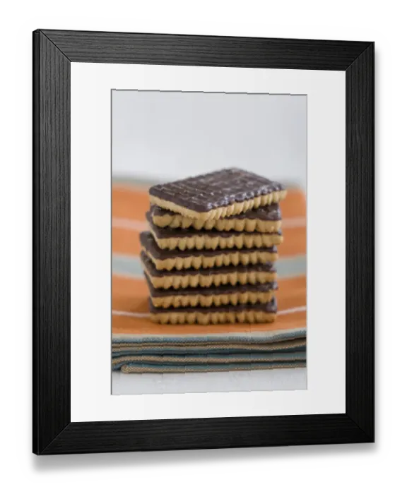 Framed Print : Stack of chocolate ginger biscuits on orange napkin credit: Marie-Louise Avery Framed Print : Stack of chocolate ginger biscuits on orange napkin credit: Marie-Louise Avery