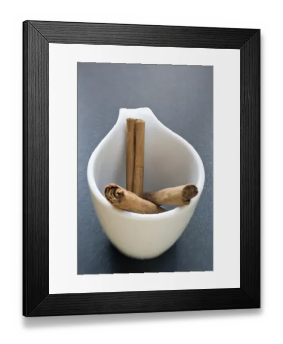 Framed Print : Sticks of cinnamon in small white cup credit: Marie-Louise Avery  /  thePictureKitchen
