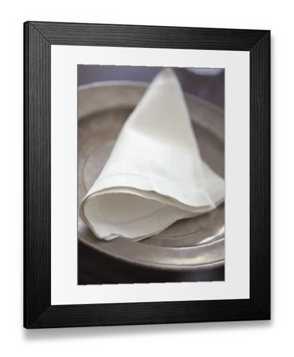 Framed Print : Folded linen napkin on pewter plate. credit: Marie-Louise Avery  /  thePictureKitchen