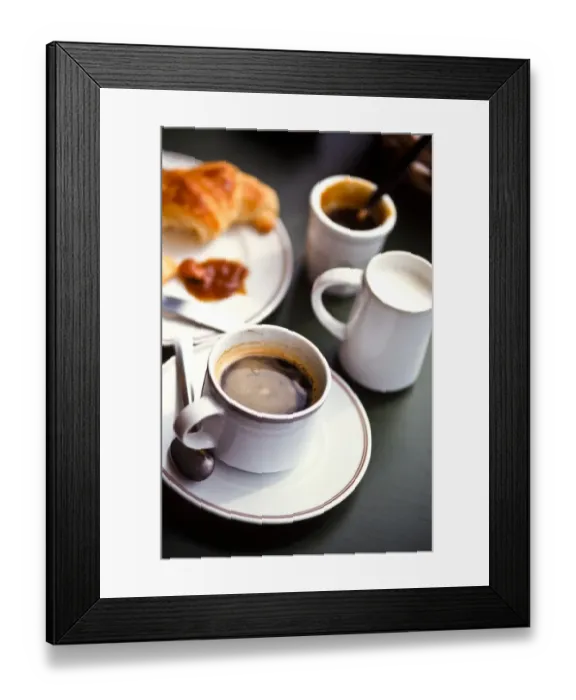 Framed Print : Coffee and croissant on cafe table in south of France credit: Marie-Louise Avery Framed Print : Coffee and croissant on cafe table in south of France credit: Marie-Louise Avery