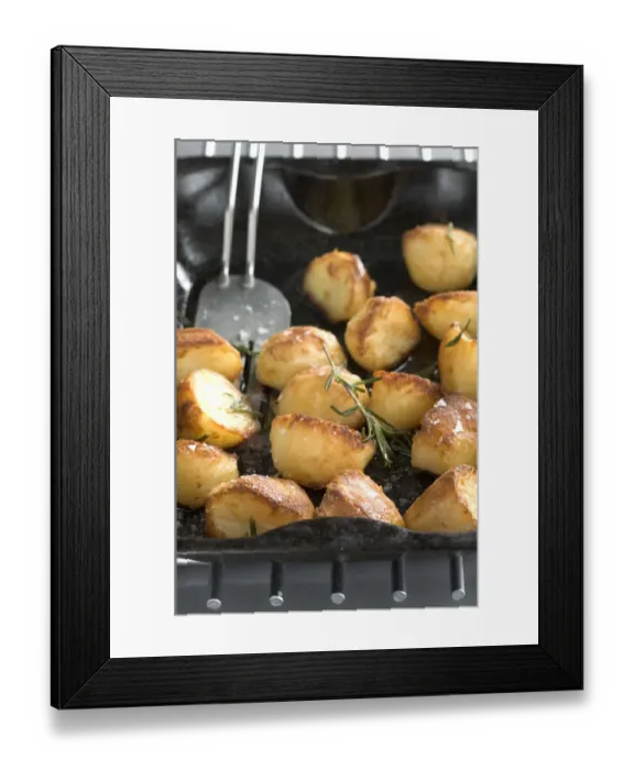 Framed Print : Roast potatoes in black roasting tin with salt and rosemary credit: Marie-Louise Framed Print : Roast potatoes in black roasting tin with salt and rosemary credit: Marie-Louise