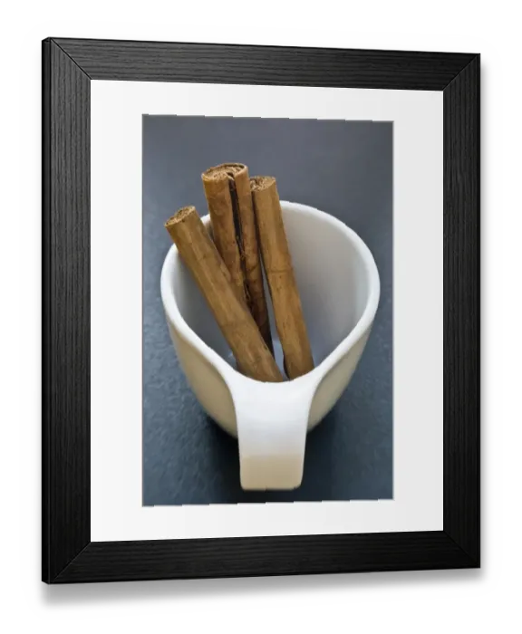 Framed Print : Sticks of cinnamon in small white cup credit: Marie-Louise Avery / thePictureKitchen Framed Print : Sticks of cinnamon in small white cup credit: Marie-Louise Avery / thePictureKitchen
