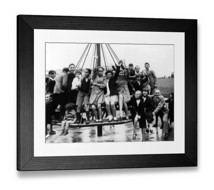 Framed Print : The childrens playground roundabout, a popular place for children after school Framed Print : The childrens playground roundabout, a popular place for children after school