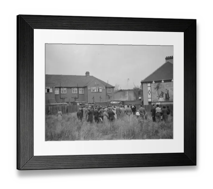 Framed Print : Crowds gather as firemen attempt to put out fires in a parade of shops in Welling, Kent Framed Print : Crowds gather as firemen attempt to put out fires in a parade of shops in Welling, Kent