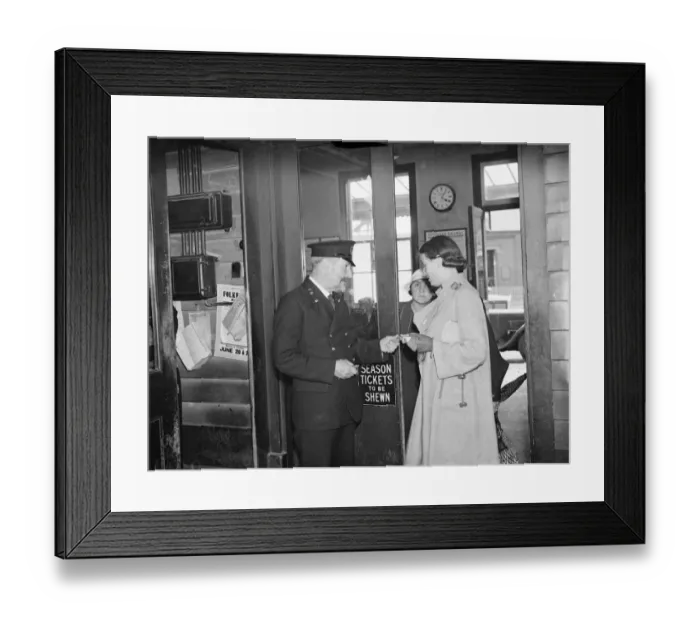 Framed Print : Fred Needham a ticket collector in Dartford, Kent, checking the ticket of a woman Framed Print : Fred Needham a ticket collector in Dartford, Kent, checking the ticket of a woman
