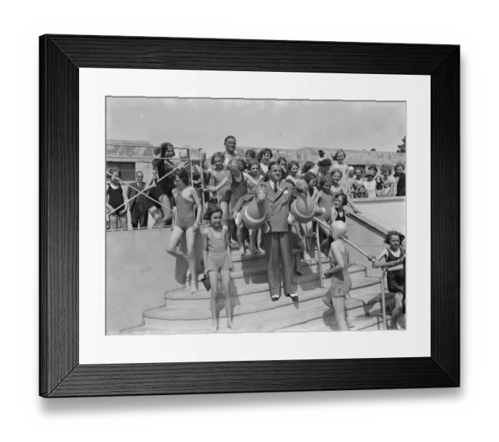 Framed Print : The Swanscombe Baths in Kent. Mr Behar poses with two Inflatable birds. The children