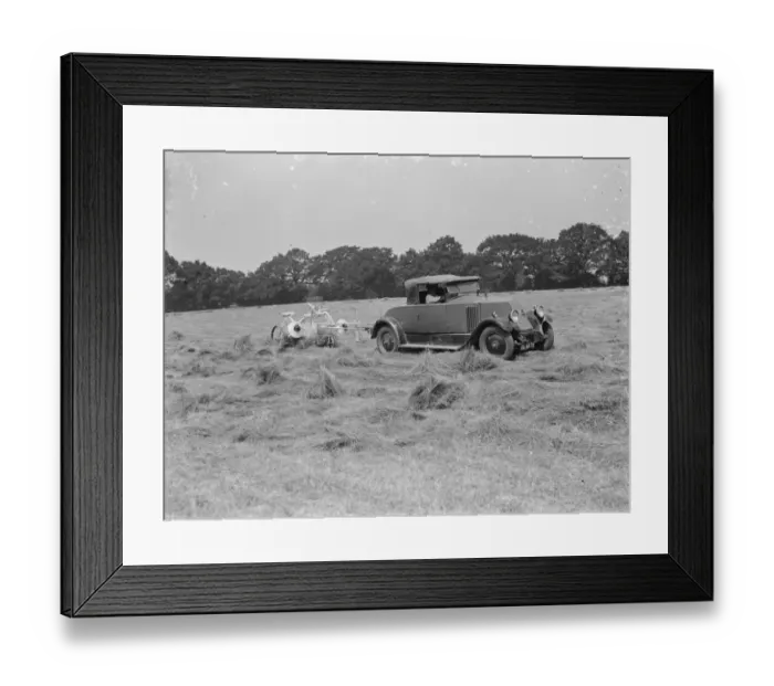 Framed Print : A farmer haymaking in a field using a car to pull the machinery. 1939 Framed Print : A farmer haymaking in a field using a car to pull the machinery. 1939