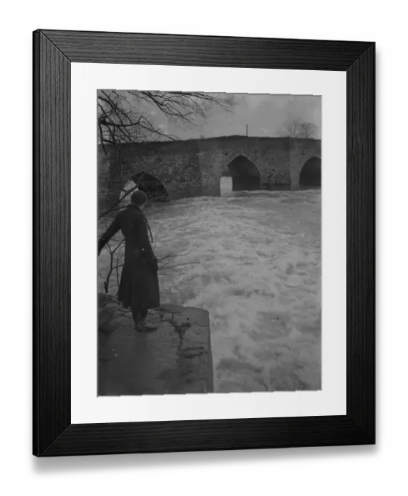 Framed Print : A full, rushing river at the ancient stone bridge at Yalding in Kent after flooding