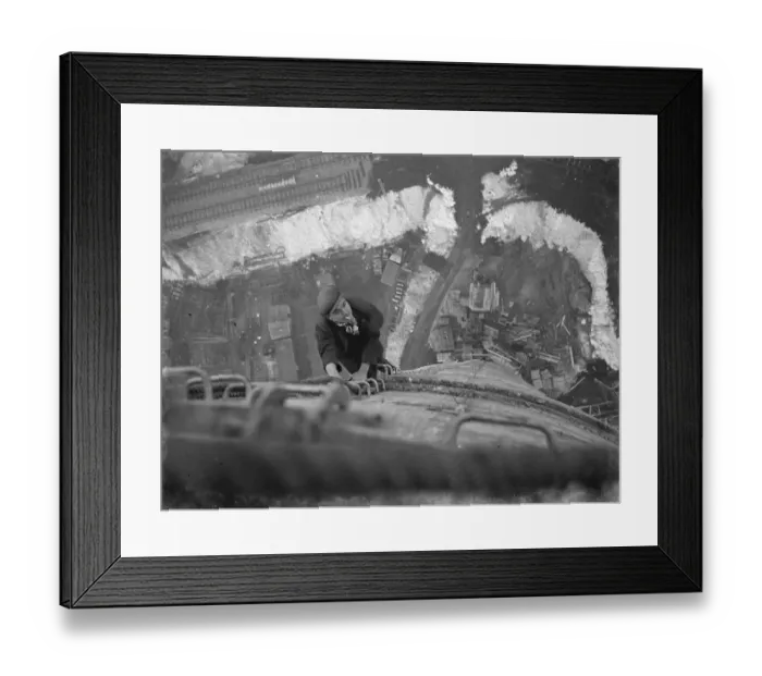 Framed Print : A workman climbs up on of the chimneys of the new coal electric power station under Framed Print : A workman climbs up on of the chimneys of the new coal electric power station under