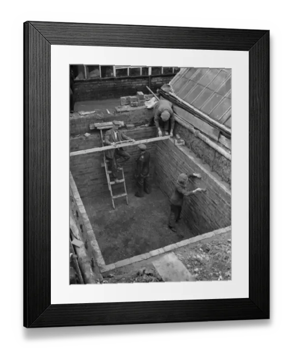 Framed Print : Building the outer foundations for an air raid shelter in a garden in Hextable
