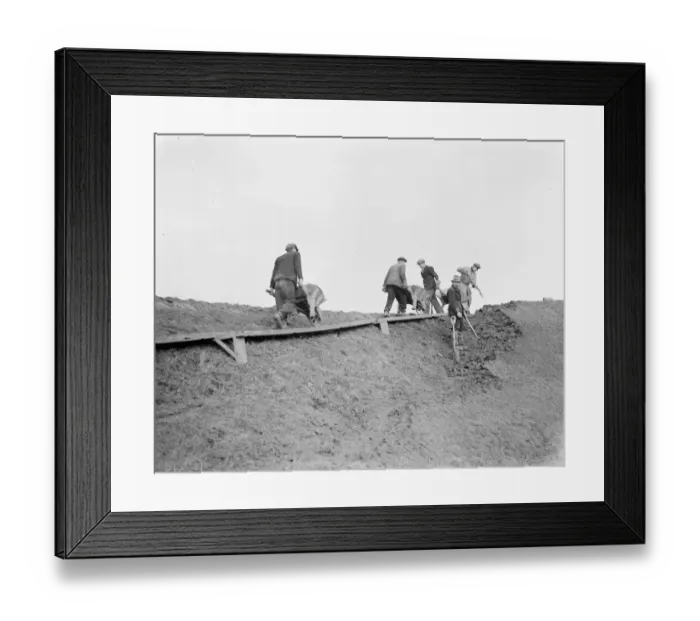 Framed Print : Workers increasing the river defences and doing repairs on the river wall and embankment Framed Print : Workers increasing the river defences and doing repairs on the river wall and embankment