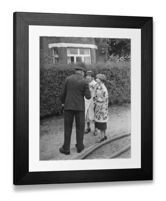 Framed Print : Firemen respond to a house fire in Chislehurst, Kent. A policeman speaks to Mrs